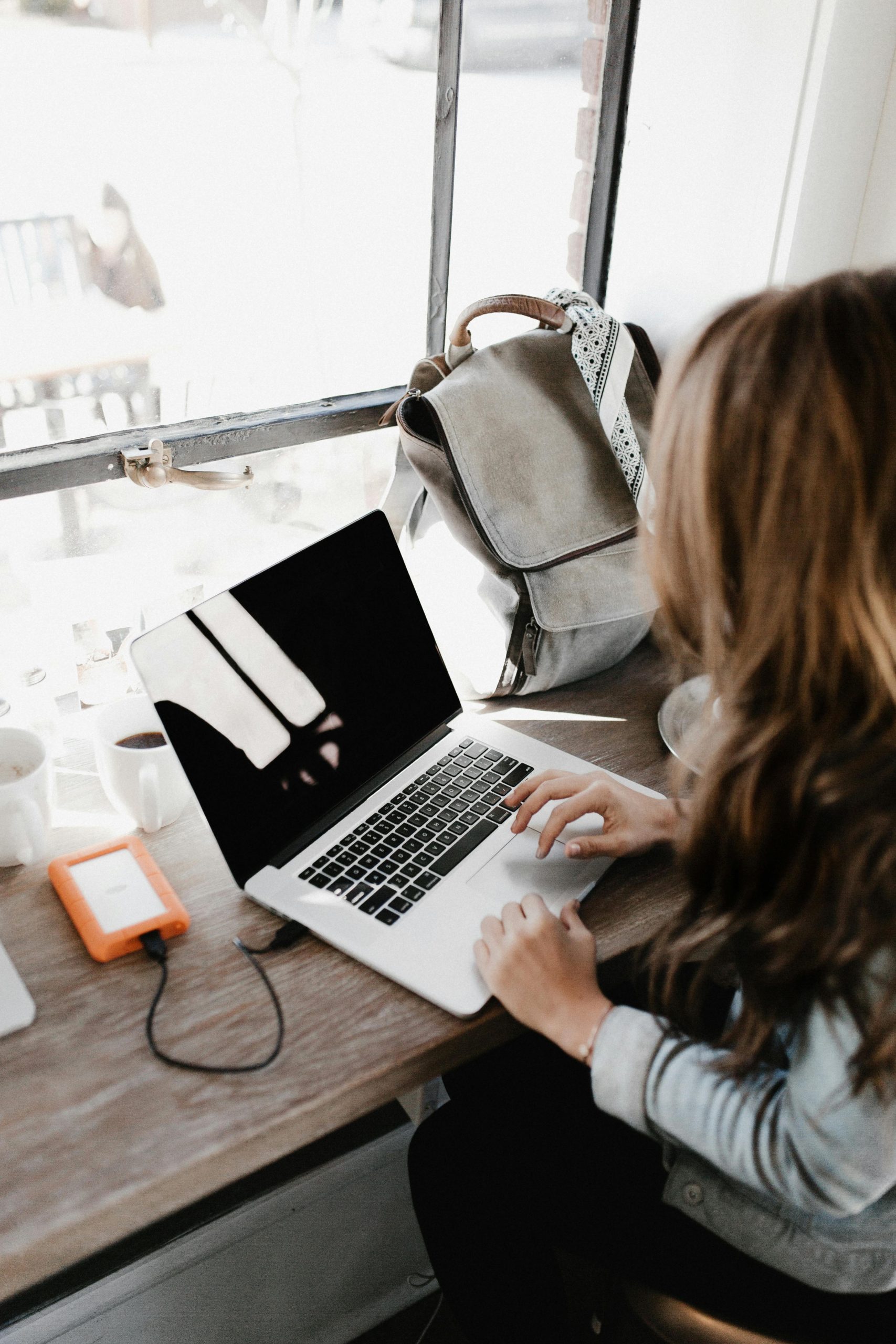 a person at a desk using a laptop