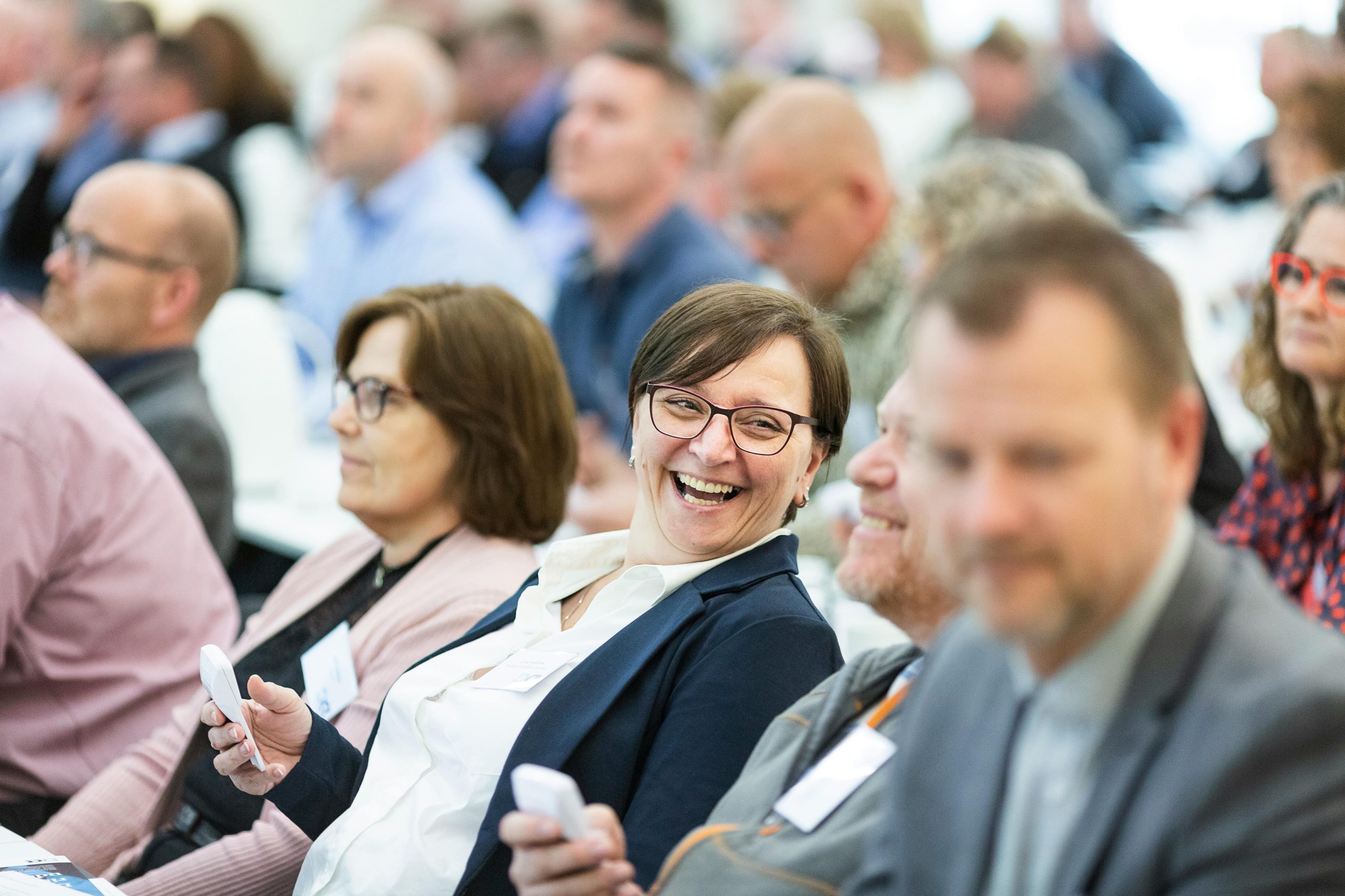 a number of people sitting down facing the same way - at a Charity tax conference or presentation