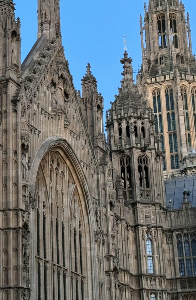 A close up of the houses of parliament. There are ornate pillars and columns.